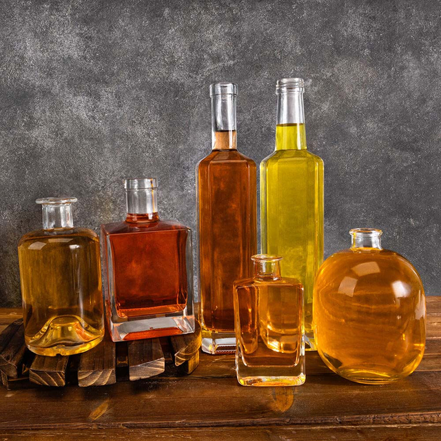 In bottiglie di vetro a liquore rotondo quadrato trasparente